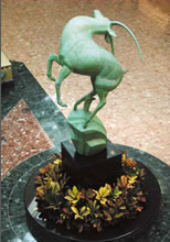 Statue of leaping gazelle inside building